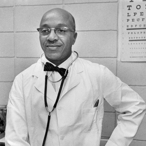 Man stands with stethoscope around neck and pen in pocket