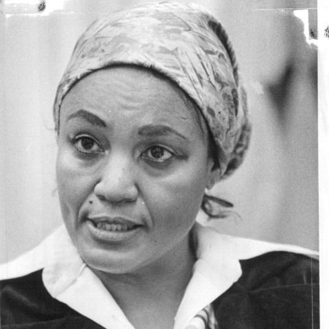 photo of woman with scarf pointing in conversation